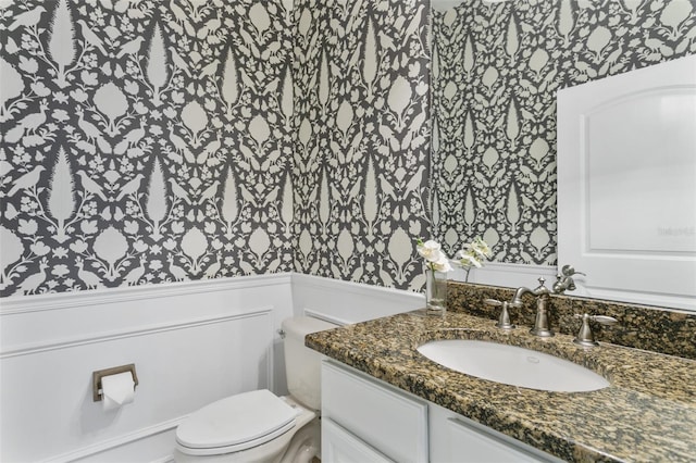 bathroom with toilet and vanity