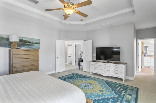 carpeted bedroom featuring ceiling fan, crown molding, and a tray ceiling