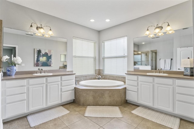 bathroom with plus walk in shower, tile patterned flooring, and vanity