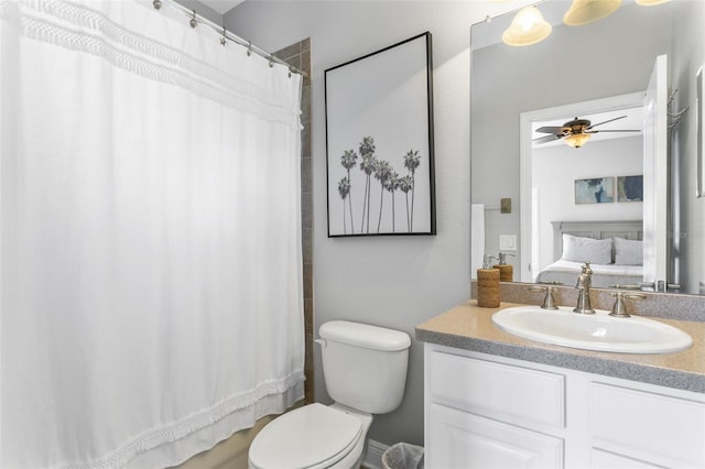 bathroom with toilet, vanity, and ceiling fan