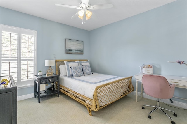 carpeted bedroom with ceiling fan and multiple windows