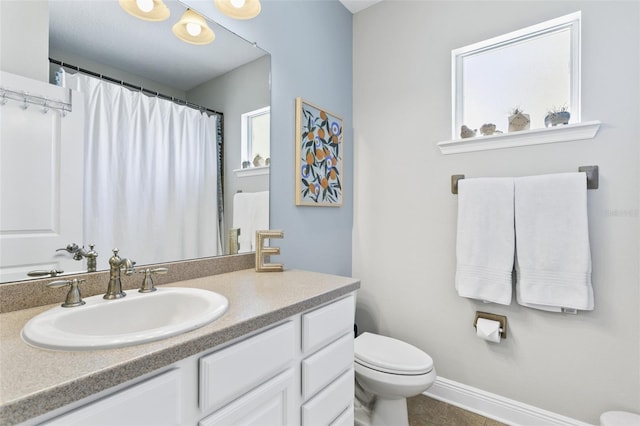 bathroom featuring toilet and vanity