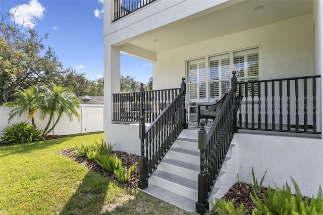 entrance to property with a lawn