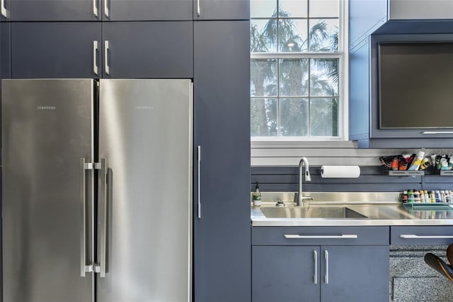 kitchen with sink and high end fridge