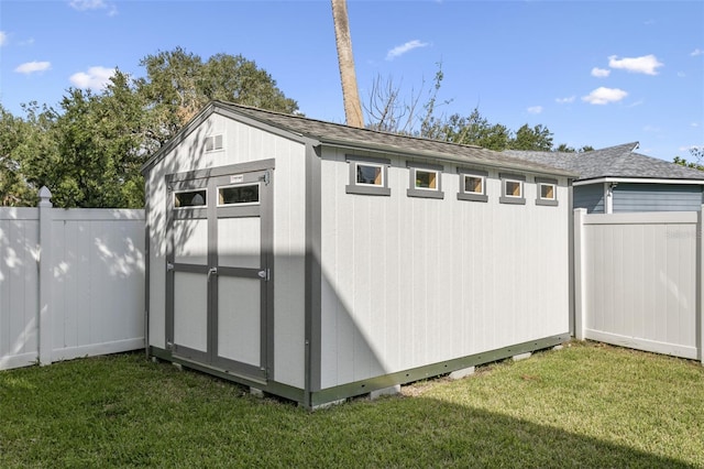 view of outbuilding with a yard