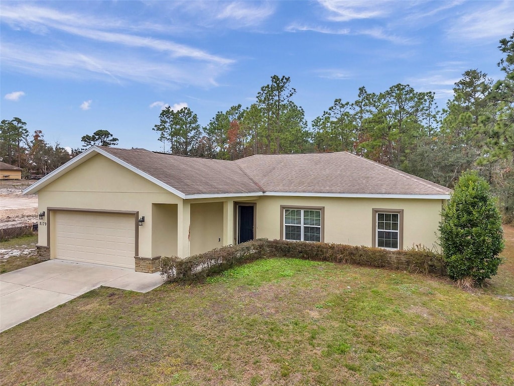 single story home featuring a front yard and a garage