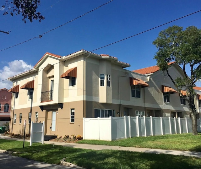 view of side of home with a yard