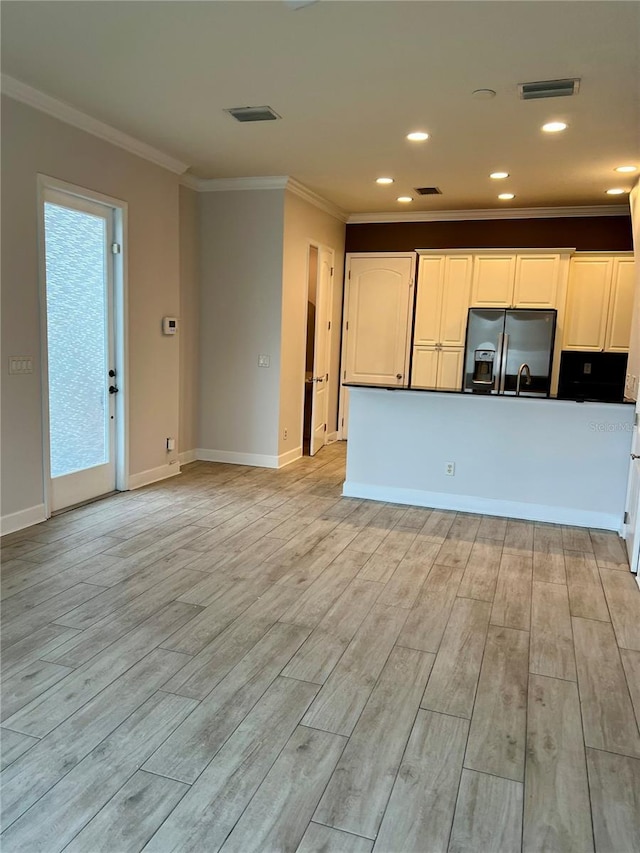 kitchen with light wood-style flooring, black fridge with ice dispenser, white cabinetry, and crown molding