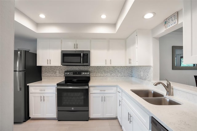 kitchen with sink, white cabinetry, and appliances with stainless steel finishes