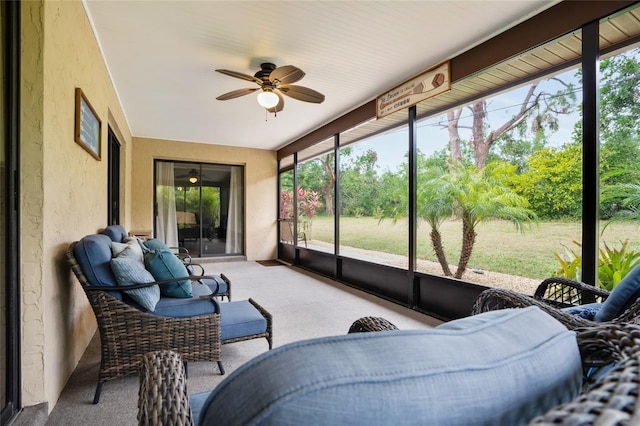 sunroom / solarium featuring ceiling fan