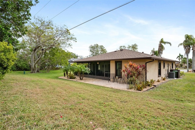 rear view of property with a patio, a lawn, and central air condition unit