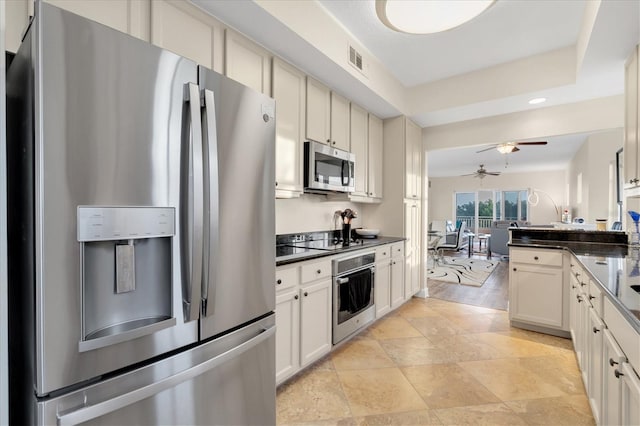 kitchen featuring stainless steel appliances, white cabinetry, and ceiling fan