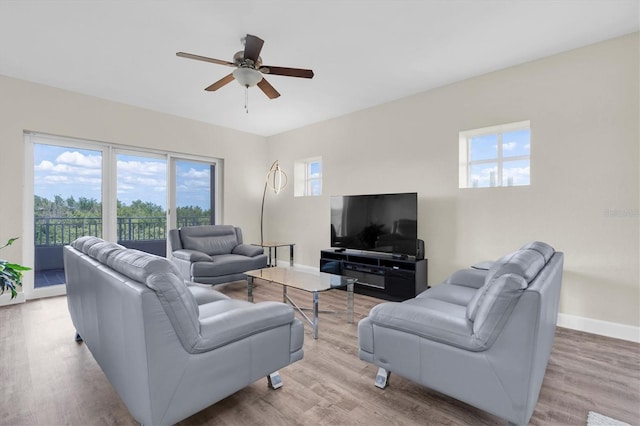 12077 Gandy Blvd N Unit 344, Saint Petersburg, FL 33702 - living room featuring healthy amount of natural light, ceiling fan, and baseboards