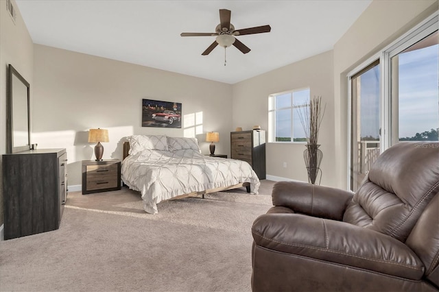 12077 Gandy Blvd N Unit 344, Saint Petersburg, FL 33702 - bedroom featuring light colored carpet, baseboards, a ceiling fan, and access to exterior