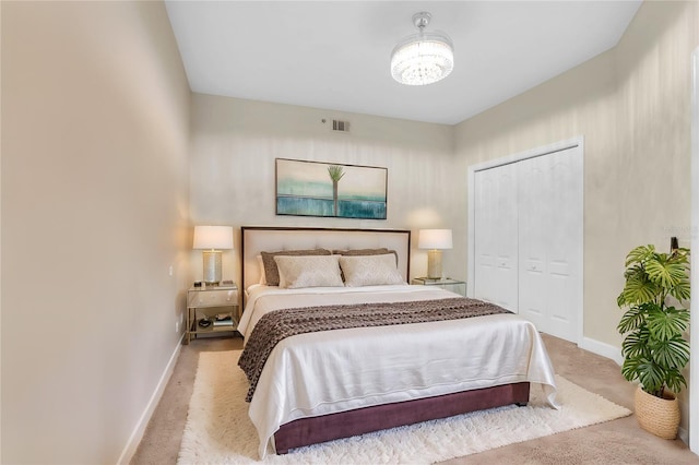 12077 Gandy Blvd N Unit 344, Saint Petersburg, FL 33702 - bedroom featuring carpet, baseboards, a closet, and a chandelier