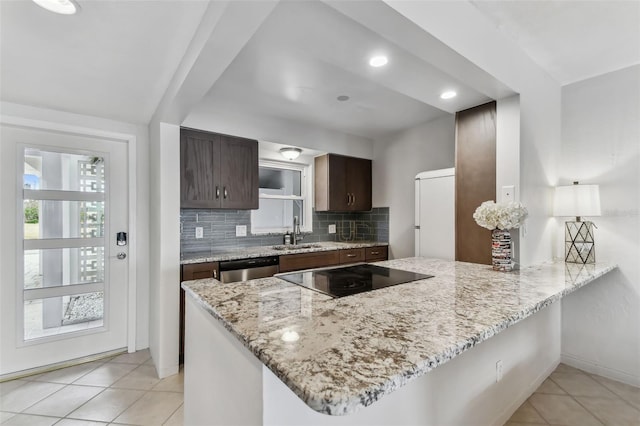 kitchen featuring tasteful backsplash, sink, white fridge, stainless steel dishwasher, and kitchen peninsula