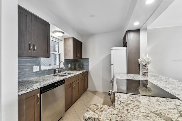 kitchen with sink, stove, light stone counters, decorative backsplash, and stainless steel dishwasher