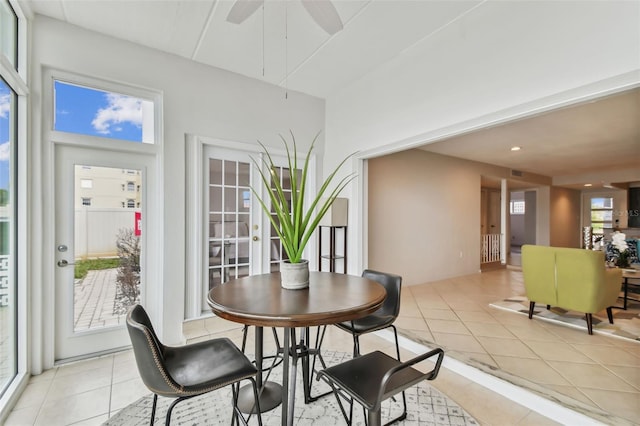 dining space with ceiling fan and light tile patterned flooring