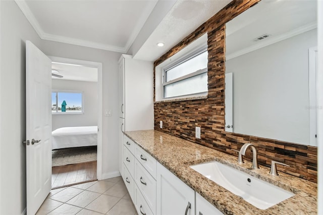 bathroom featuring crown molding, backsplash, tile patterned floors, and vanity