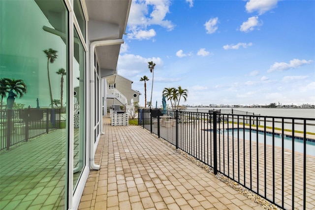 balcony with a water view and a patio