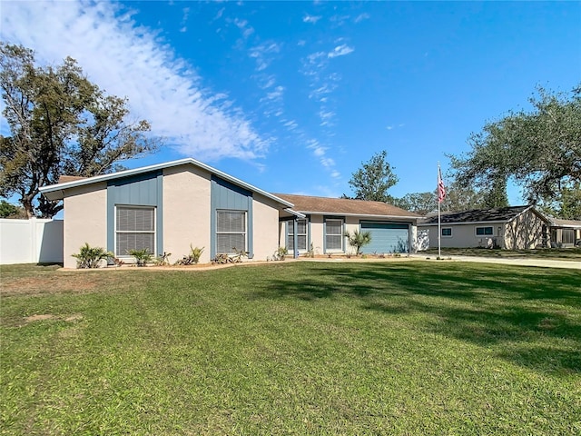 view of front of house with a garage and a front yard