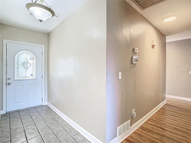 foyer entrance with light tile patterned floors