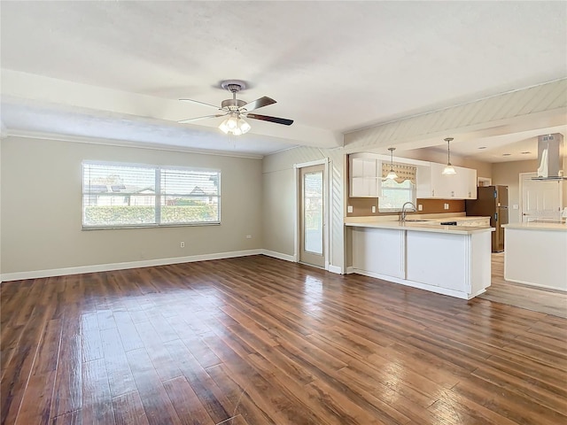 unfurnished living room with ceiling fan, ornamental molding, dark hardwood / wood-style floors, and sink