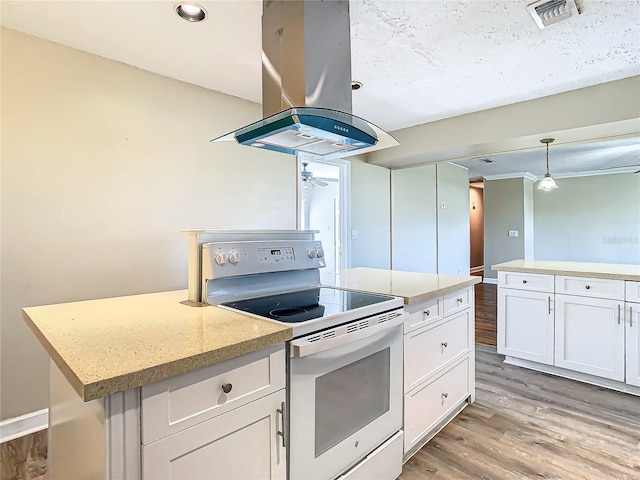 kitchen with island range hood, white electric range, white cabinets, hanging light fixtures, and a center island