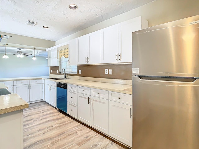 kitchen featuring dishwasher, sink, white cabinets, stainless steel fridge, and light hardwood / wood-style floors