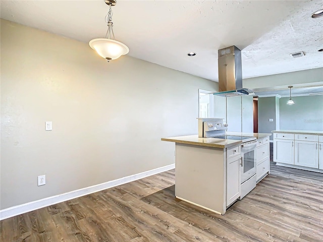 kitchen with white cabinetry, hanging light fixtures, island exhaust hood, white electric range oven, and a kitchen island