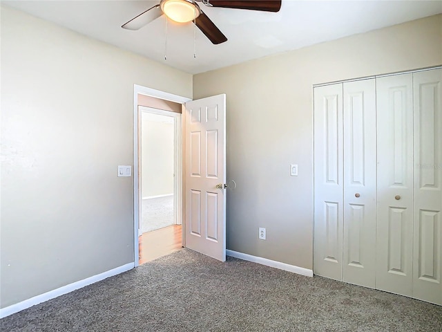 unfurnished bedroom with carpet floors, a closet, and ceiling fan