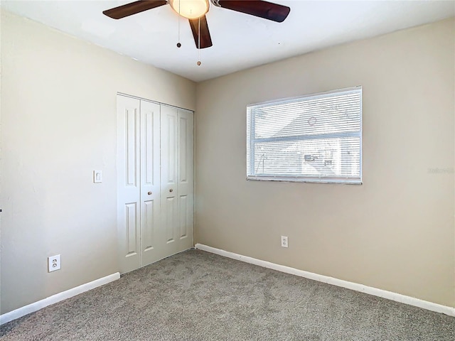 unfurnished bedroom featuring ceiling fan, light carpet, and a closet