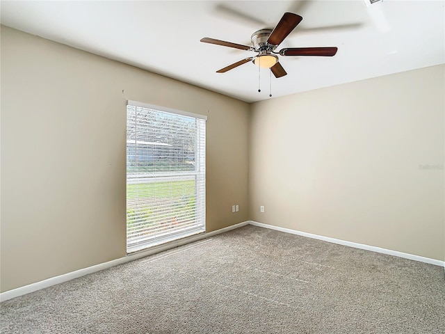 spare room featuring ceiling fan and carpet flooring