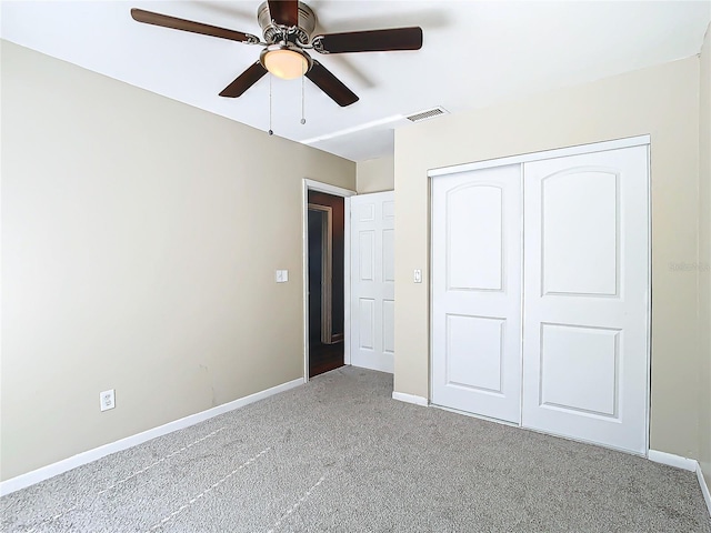 unfurnished bedroom featuring light carpet, ceiling fan, and a closet