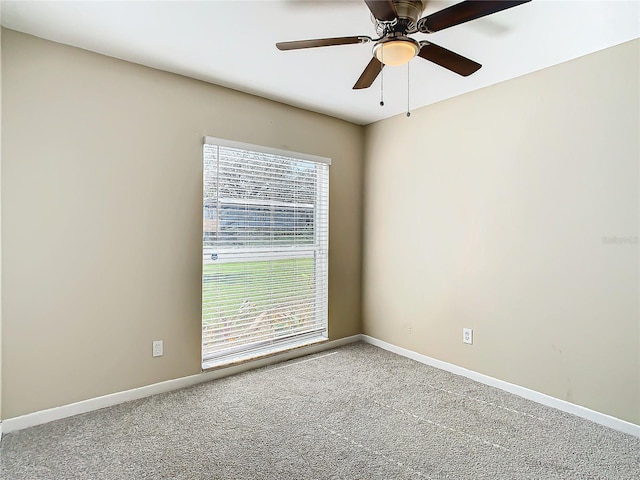 spare room featuring plenty of natural light, ceiling fan, and carpet flooring