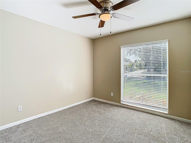 unfurnished room with ceiling fan, a healthy amount of sunlight, and carpet flooring