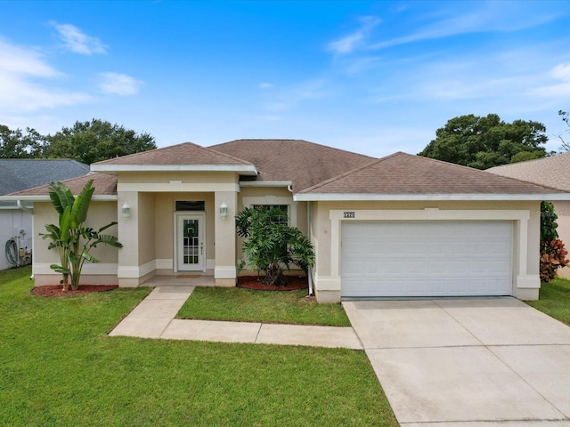 view of front of house featuring a front lawn and a garage