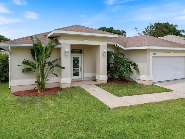 view of front of home with a garage and a front lawn