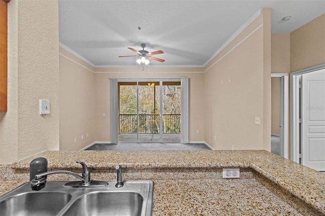 kitchen with crown molding, ceiling fan, and sink