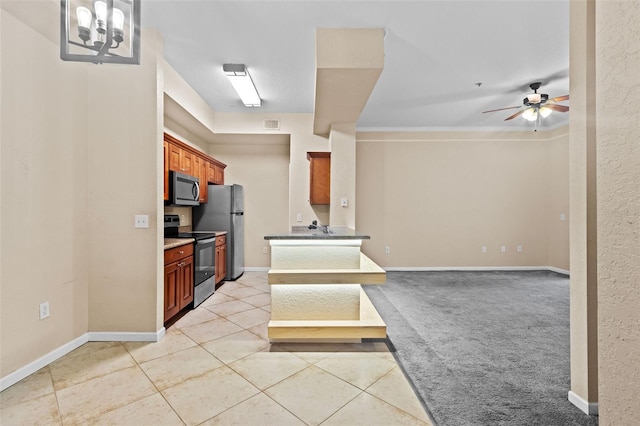 kitchen featuring light tile patterned flooring, ceiling fan, and appliances with stainless steel finishes