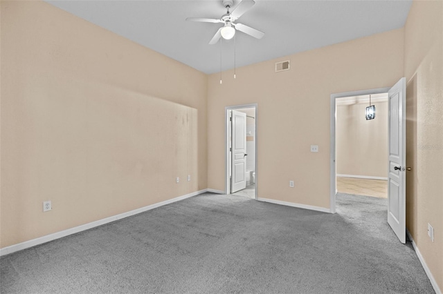 unfurnished bedroom with ceiling fan, ensuite bathroom, and light colored carpet