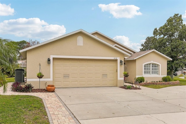 view of front of home with a garage and cooling unit