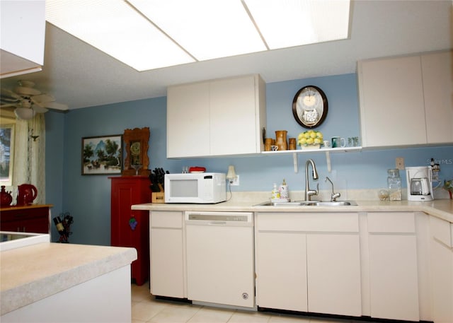 kitchen featuring sink, white appliances, white cabinets, and ceiling fan