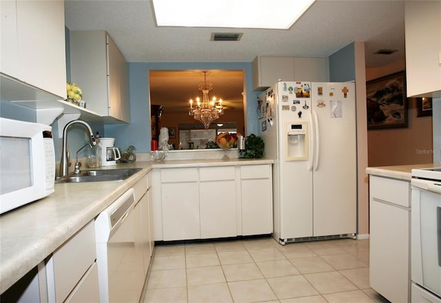 kitchen with sink, white cabinetry, an inviting chandelier, hanging light fixtures, and white appliances