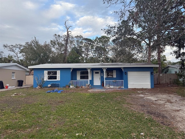 single story home featuring a front yard, a garage, and a porch