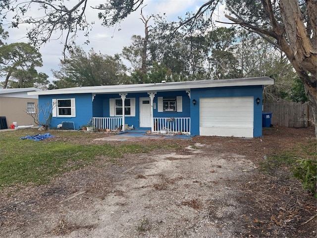 single story home with a front yard, covered porch, a garage, and cooling unit