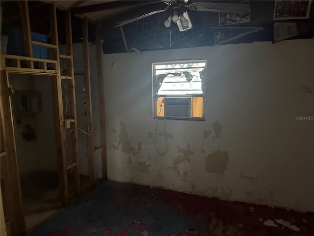 basement with ceiling fan and cooling unit