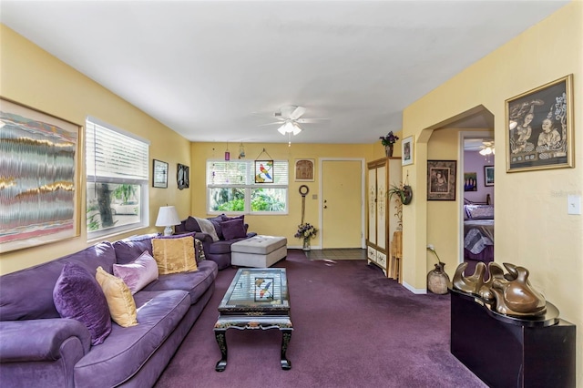 carpeted living room with ceiling fan