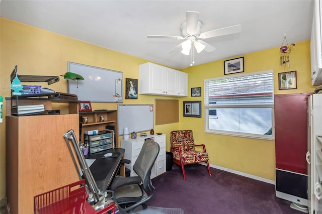 office space featuring ceiling fan and dark carpet