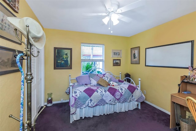 bedroom featuring ceiling fan and dark carpet